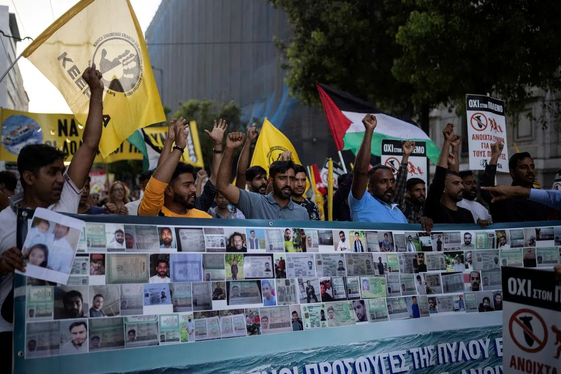 FILE PHOTO: Protesters, some of them survivors of a deadly migrant shipwreck off southwestern Greece, hold a banner with photos of the missing during a demonstration marking a year from the shipwreck, in Athens Greece, June 14, 2024. REUTERS/Alkis Konstantinidis/File Photo