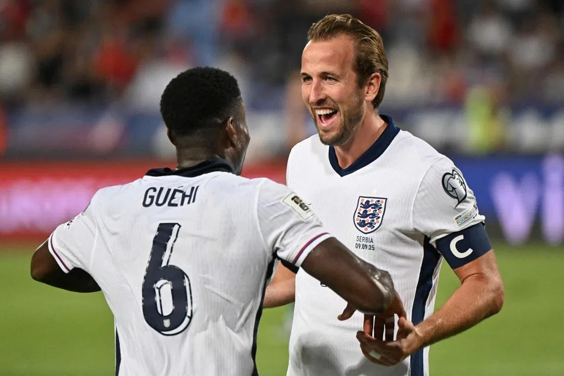 England defender Marc Guehi celebrates with teammate Harry Kane after scoring England's fourth of five goals against Serbia.