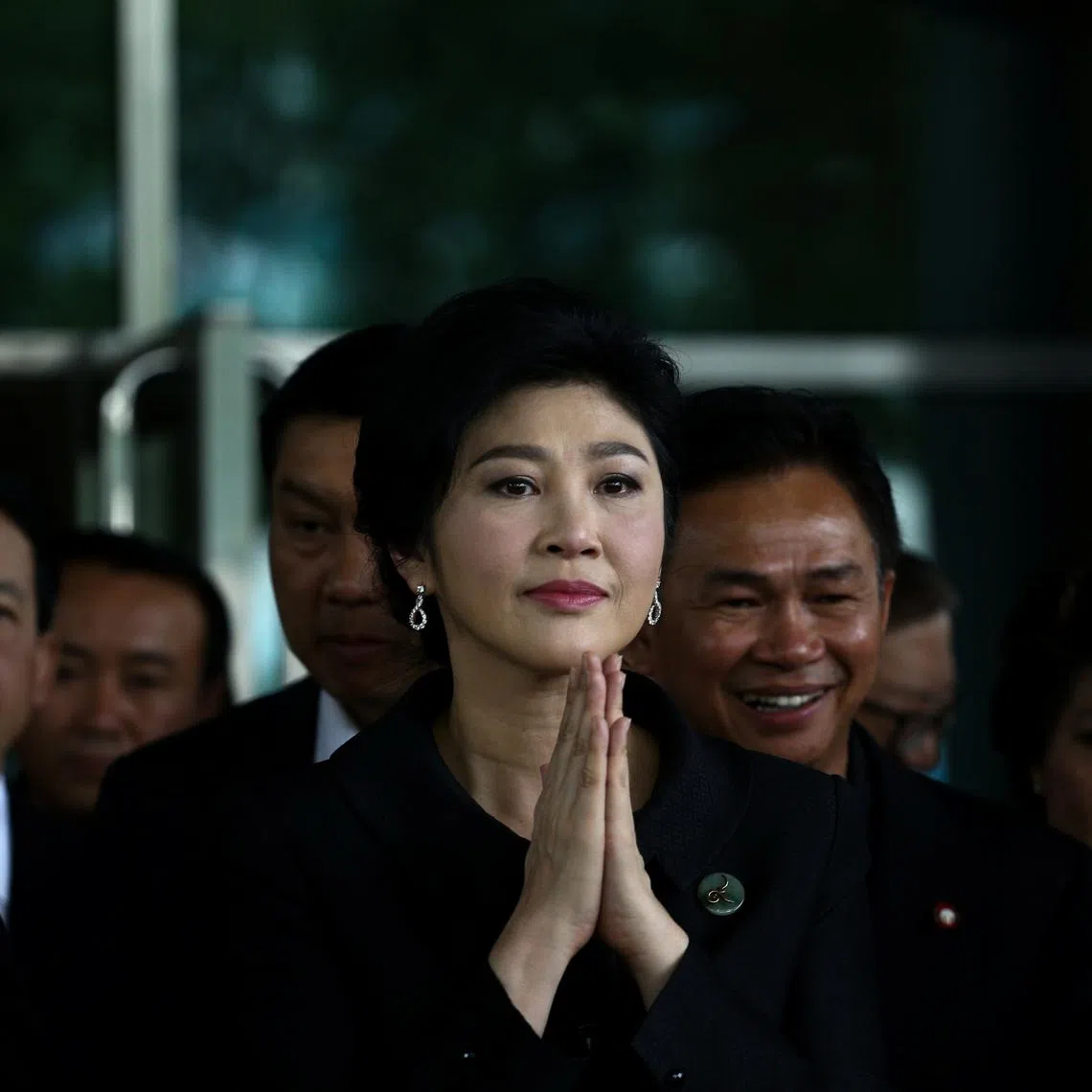 Ousted former Thai prime minister Yingluck Shinawatra greets supporters as she arrives at the Supreme Court in Bangkok, Thailand, July 21, 2017. REUTERS/Athit Perawongmetha/File Photo