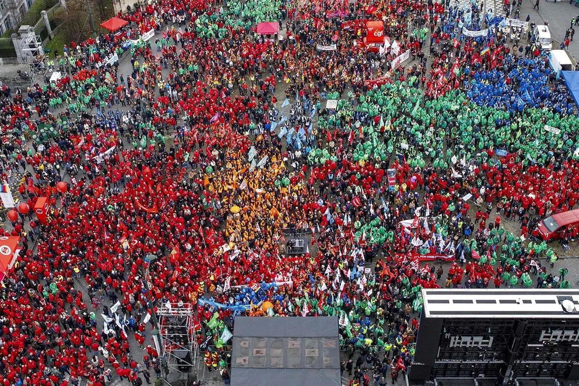 TOPSHOT - This photograph taken on December 12, 2023 in Brussels shows a demonstration, called for by the European Trade Union Confederation, against European Union's measures to overhaul rules on government spending, which many perceive will reintroduce austerity. Finance ministers at European level have been working on reforms to the EU's rules limiting debt and deficits for member states, curtailing the options of nations seeking to spend their way out of a crisis, potentially forcing them into austerity. (Photo by HATIM KAGHAT / Belga / AFP) / Belgium OUT