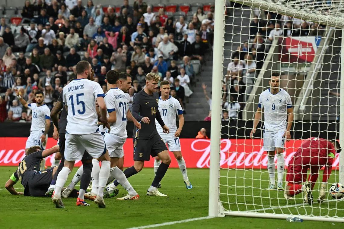 England's striker Harry Kane (left) scores the team's third goal.