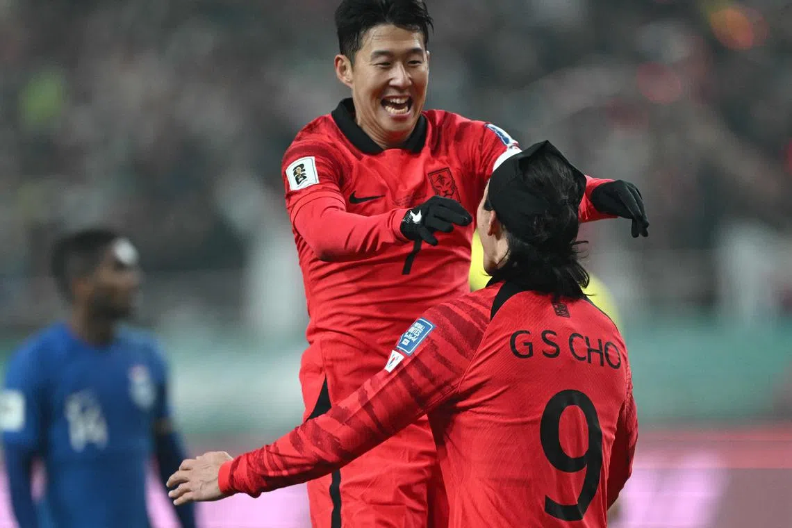 South Korea forward Cho Gue-sung (No. 9) celebrating his goal with captain Son Heung-min (top) during their 5-0 win over Singapore in a World Cup qualifiers in Seoul On Nov 16.