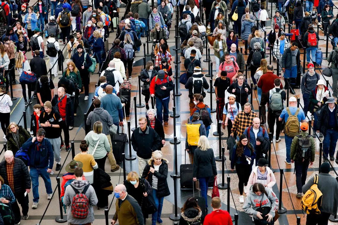 Long queues at Denver's airport.  US airlines have cancelled more than 15,000 flights  following a deadly superstorm.