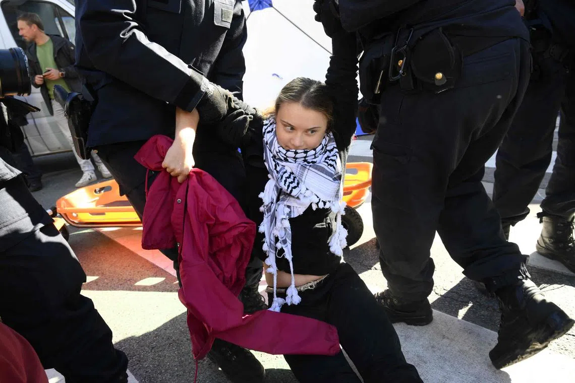 Swedish activist Greta Thunberg being arrested by police, during a climate protest against fossil fuels  in Brussels on Oct 5.