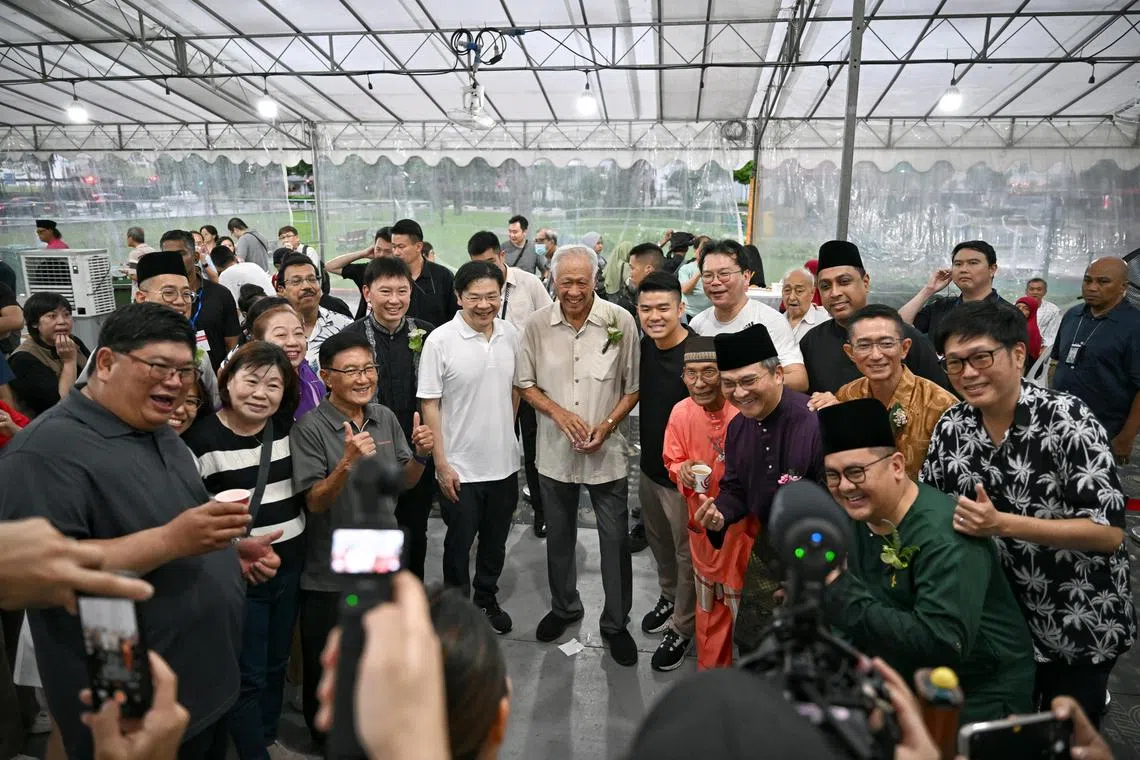 Prime Minister Lawrence Wong with Defence Minister Ng Eng Hen and Transport Minister Chee Hong Tat, taking a picture with attendees at Bishan-Toa Payoh and Marymount Hari Raya celebration at Plaza 128 on Apr 19, 2025.