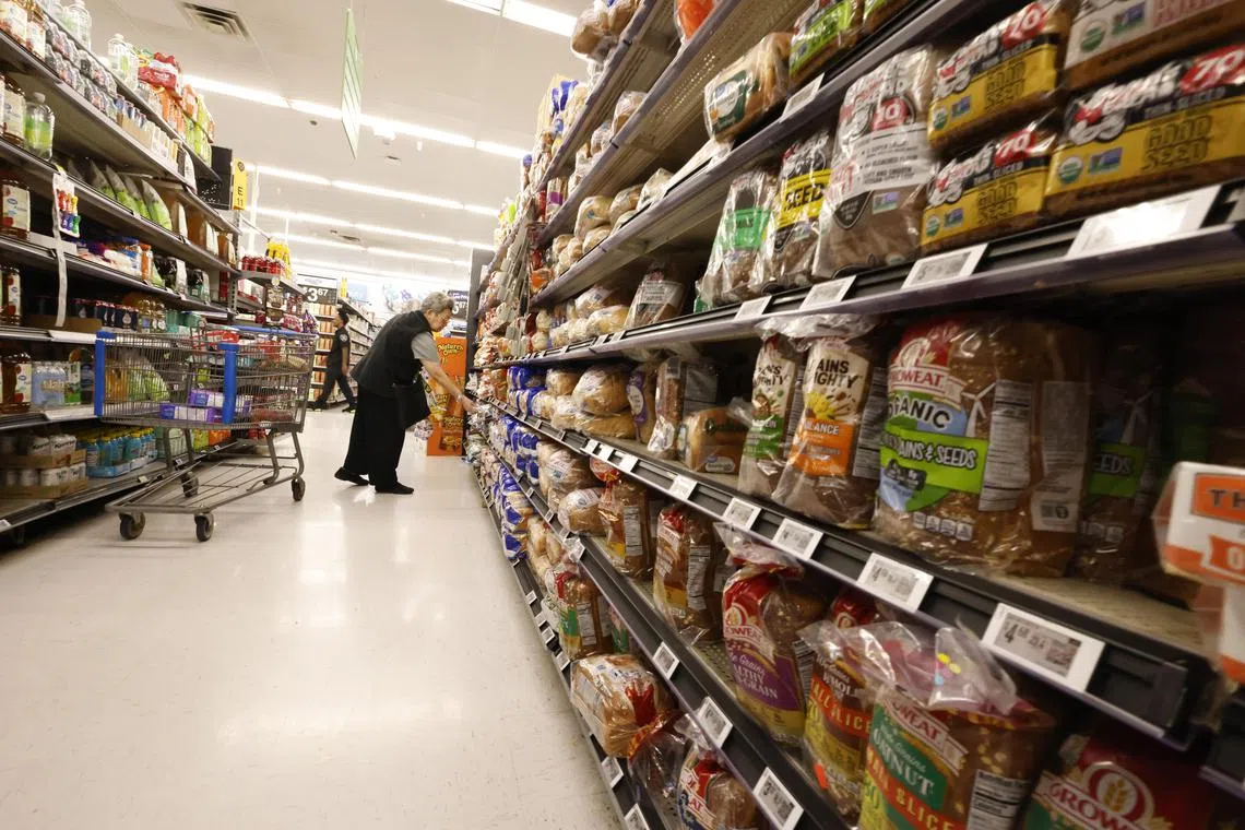 A shopper browsing the bread aisle at a Walmart store in Pleasanton, California, on May 16.