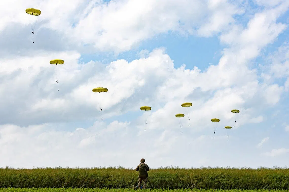 Paratroopers jump into Normandy to pay tribute to the soldiers who parachuted in on D-Day, in Sannerville, Normandy, on June 5.