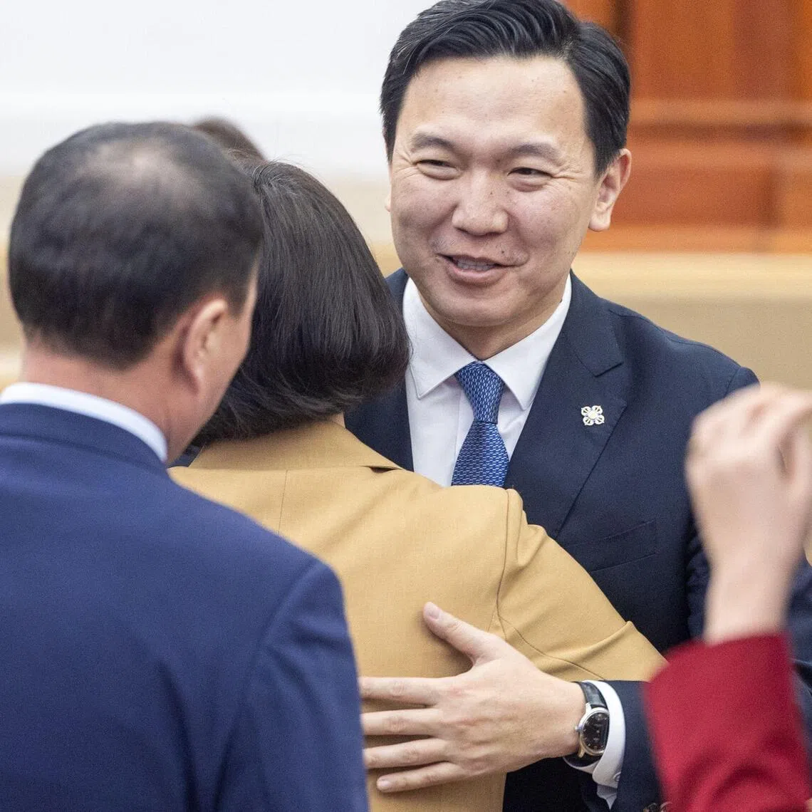 Mongolia's new Prime Minister Nyam-Osor Uchral is congratulated by members of parliament after his appointment in the capital city of Ulaanbaatar on March 30.