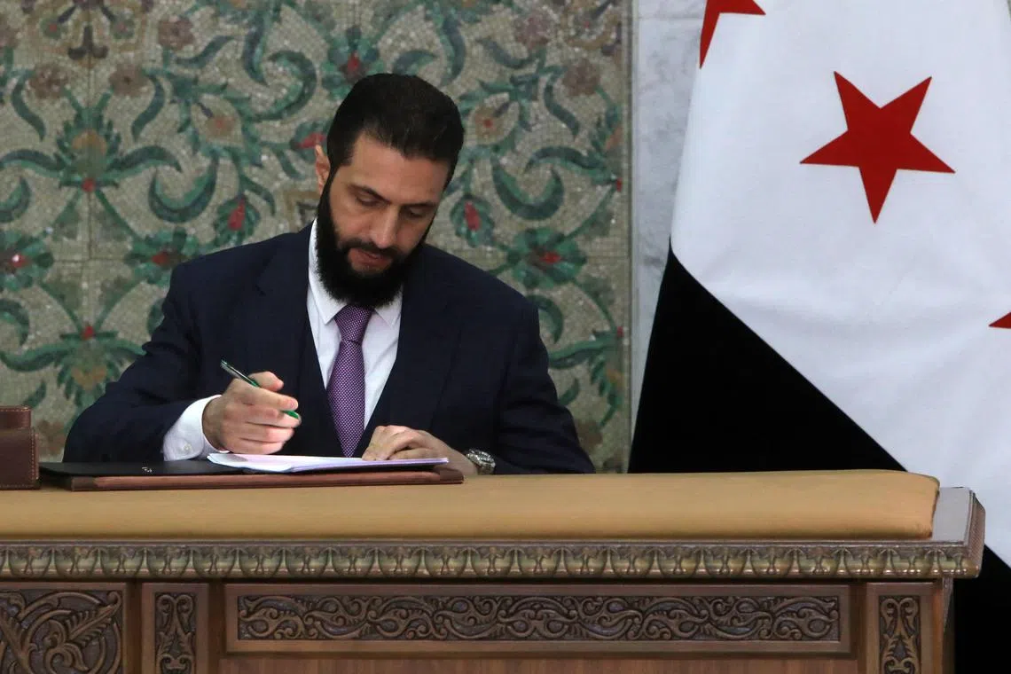 Syria's interim President, Mr Ahmad al-Sharaa, signing the country's constitutional declaration, which will be enforced throughout a five-year transitional period, at the presidential palace in Damascus, on March 13.