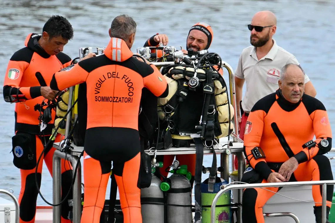 Divers of the Vigili del Fuoco, the Italian Corps. of Firefighters work in Porticello near Palermo, on August 21, 2024 two days after the British-flagged luxury yacht Bayesian sank. Rescuers with divers and an underwater drone search for six people believed trapped when the boat sank. Among the six missing were UK tech entrepreneur Mike Lynch and his 18-year-old daughter Hannah, and Jonathan Bloomer, the chair of Morgan Stanley International, and his wife Judy. The Bayesian, which had 22 people aboard including 10 crew, was anchored some 700 metres from port before dawn when it was struck by a waterspout, a sort of mini tornado. Fifteen people aboard, including a mother with a one-year-old baby, were plucked to safety; one man has been found dead; and six people remain missing. (Photo by Alberto PIZZOLI / AFP)