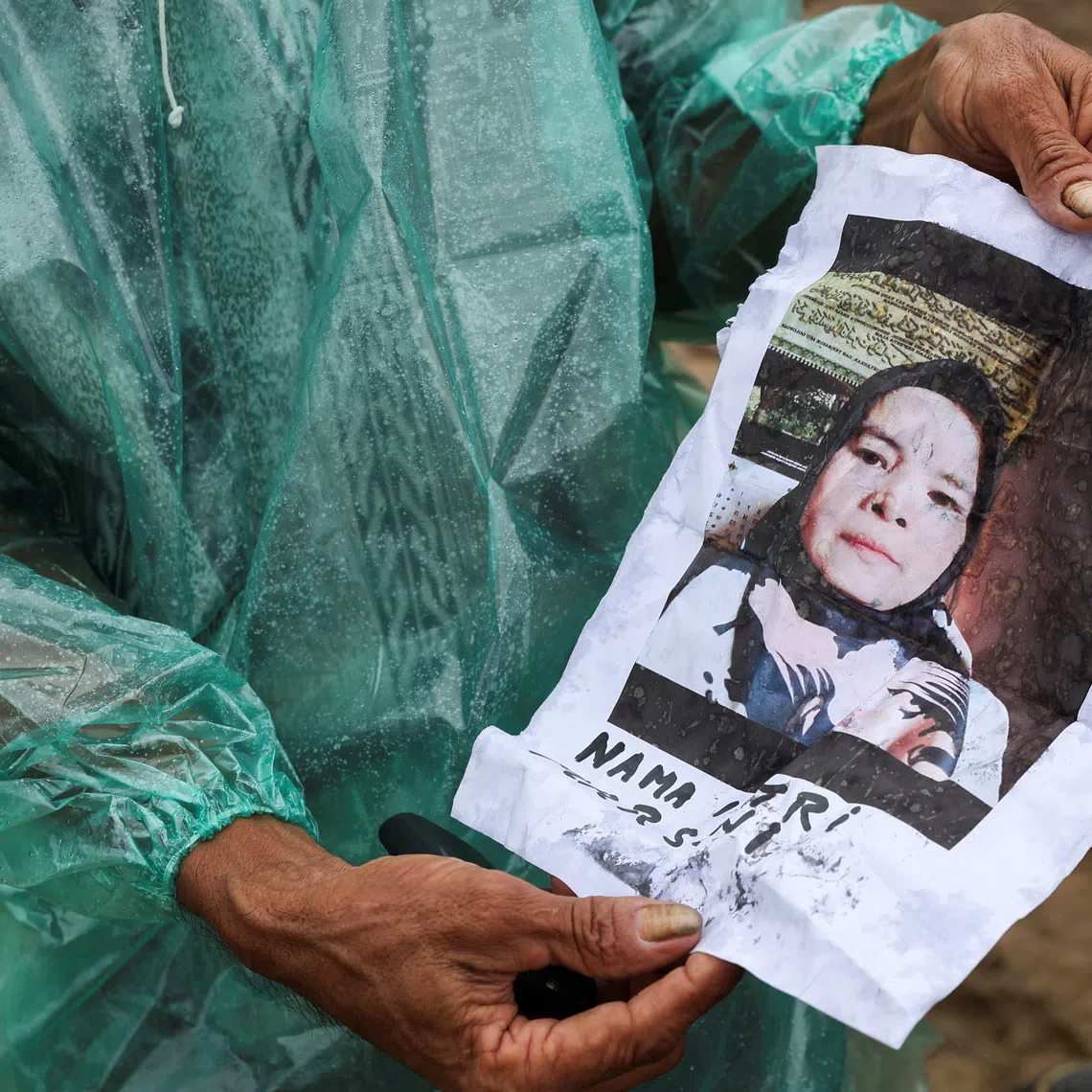 A local resident Abdul Ghani, 57, shows a photo of his wife Marsoni, who has been missing following deadly flash floods in Palembayan, Agam regency, West Sumatra province, Indonesia, December 2, 2025. REUTERS/Willy Kurniawan