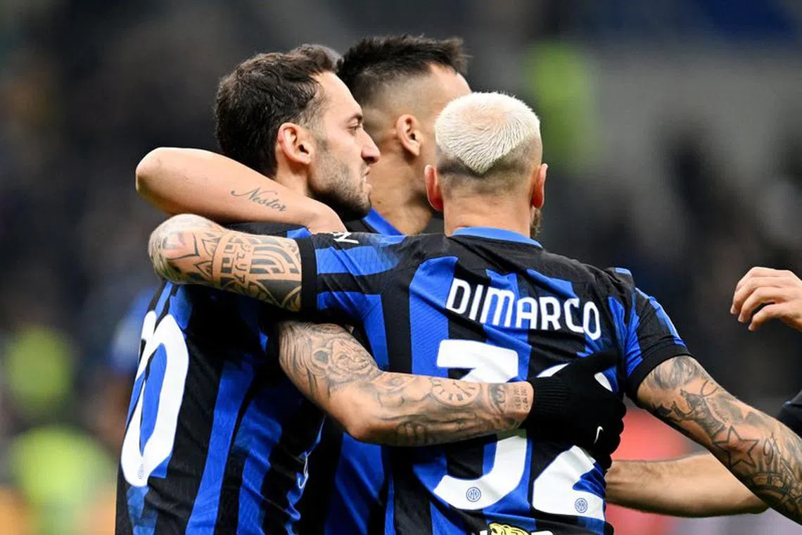 Soccer Football - Serie A - Inter Milan v Frosinone - San Siro, Milan, Italy - November 12, 2023 Inter Milan's Hakan Calhanoglu celebrates scoring their second goal with Lautaro Martinez and Federico Dimarco REUTERS/Daniele Mascolo