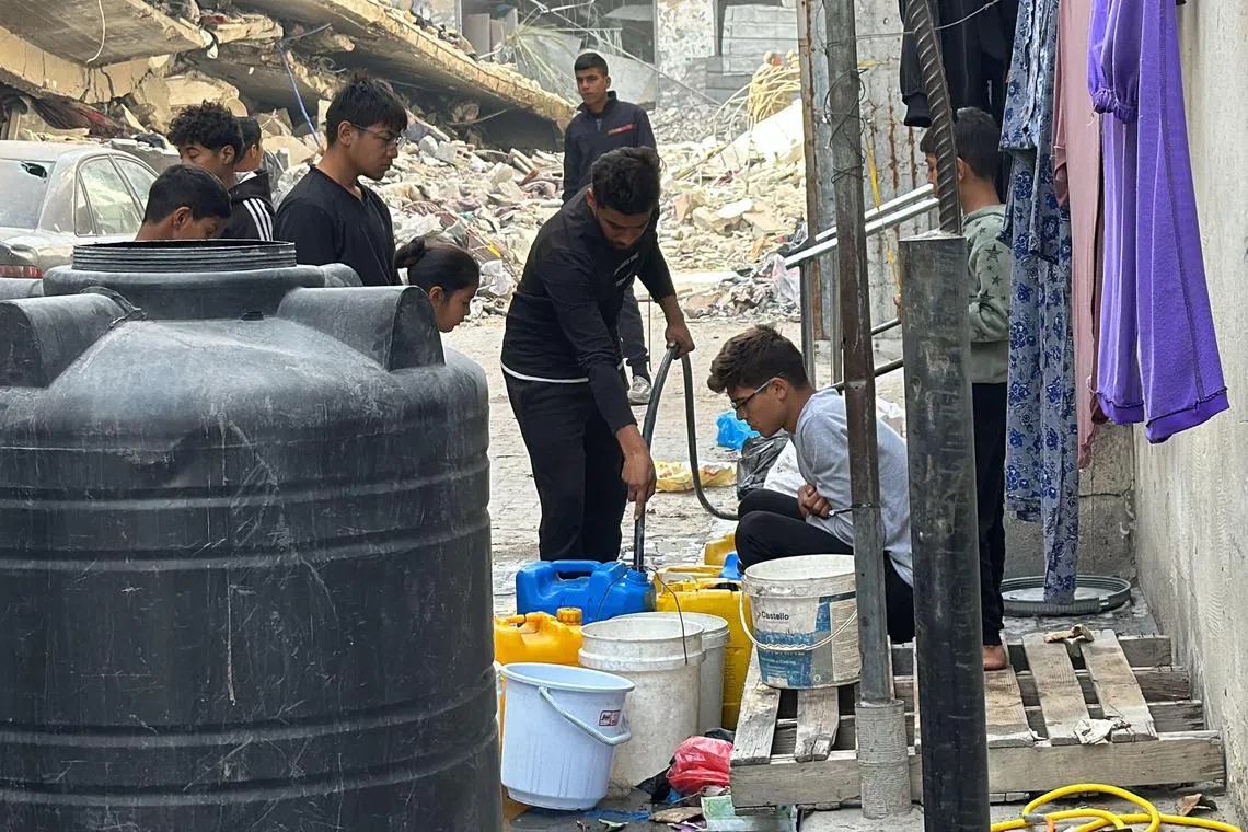 Palestinians queuing for water in Beit Lahia, in the northern Gaza Strip, on Oct 26. 