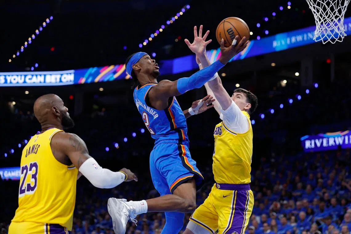 Oklahoma City Thunder guard Shai Gilgeous-Alexander goes up for a basket as Los Angeles Lakers forward Jake LaRavia defends in the second half during Game 1.