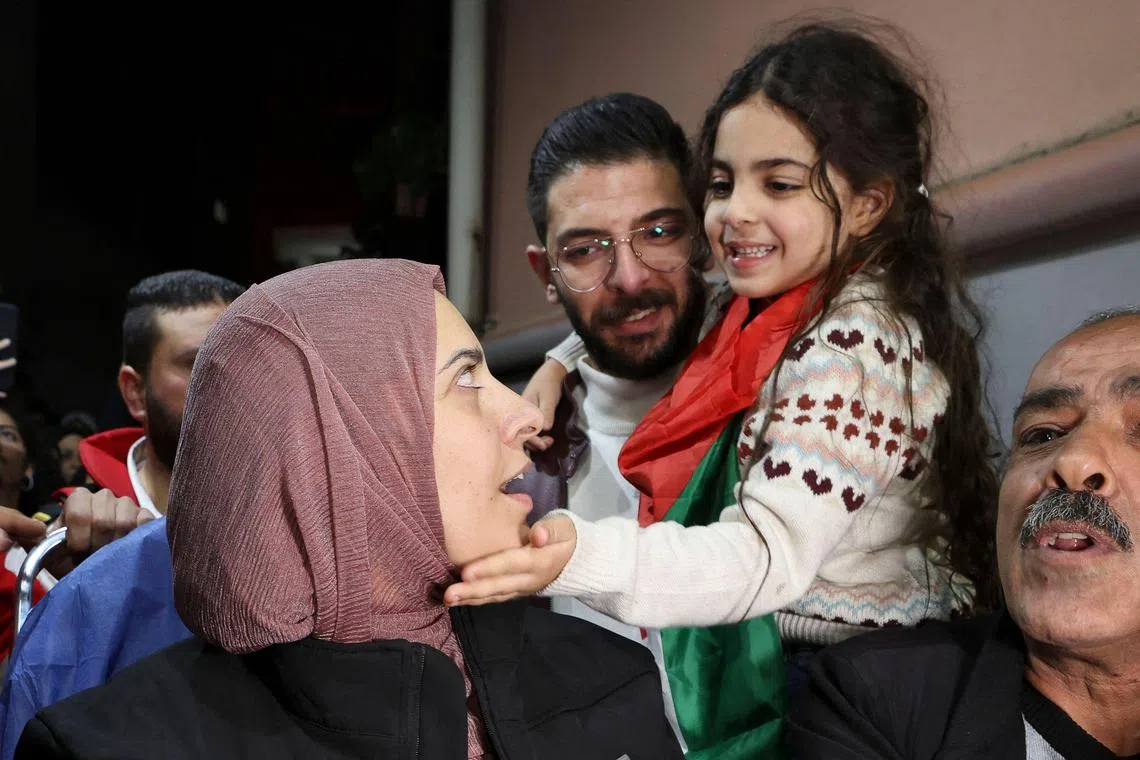 A girl gently caresses her mother's cheek after her release from an Israeli prison as part of the truce agreement between Israel and Hamas.