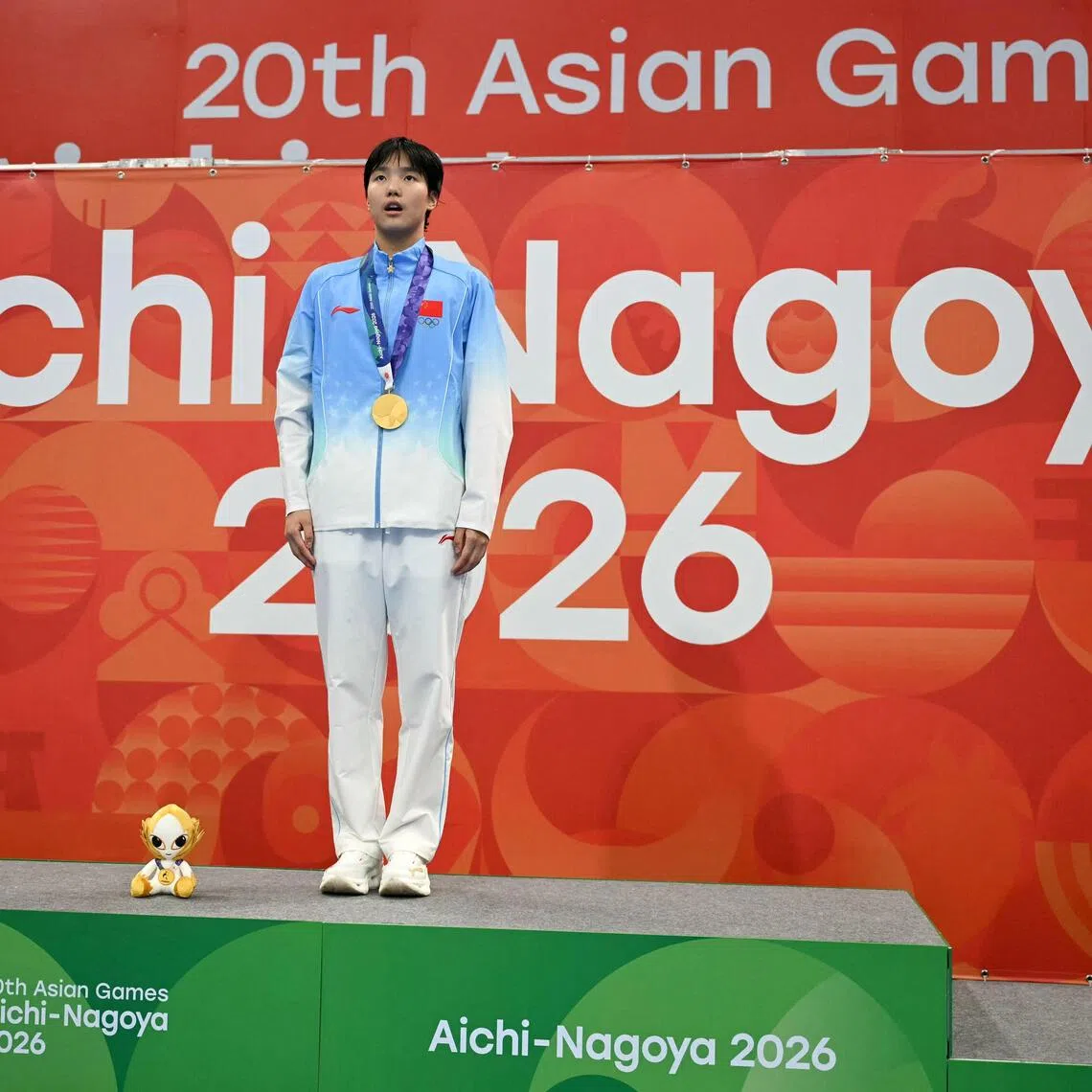 China’s Yu Zidi poses on the podium during the victory ceremony of the Asian Games women’s 400m individual medley at the Tokyo Aquatics Centre in Tokyo on Sept 23.