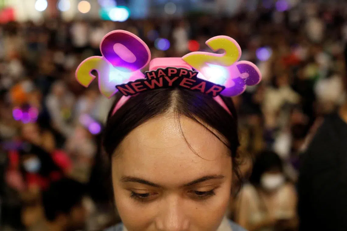A reveler wears a "2023" head band as she celebrates New Year's Eve in Kuala Lumpur, Malaysia, on Dec 31, 2022. 