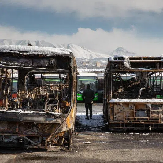 A lot full of buses burned during protests, seen during a tour for international news media in Tehran, Iran, on Jan 21, 2026. 