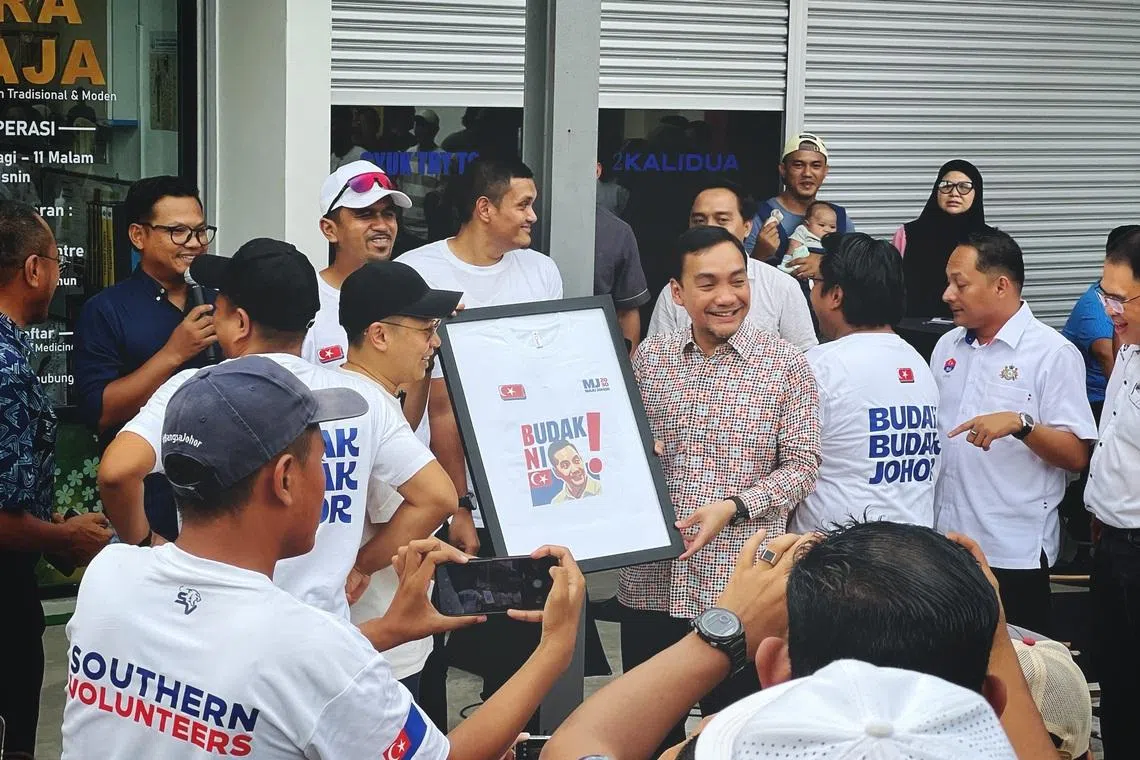 Onn Hafiz Ghazi (wearing batik) incorporates a remark denigrating him as a “budak”, or a kid, into his political campaign.