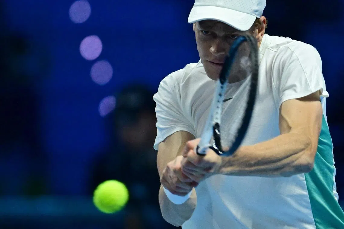 Italian Jannik Sinner returns the ball to Greek Stefanos Tsitsipas during their first round-robin match at the ATP Finals tennis tournament on November 12, 2023 in Turin.  