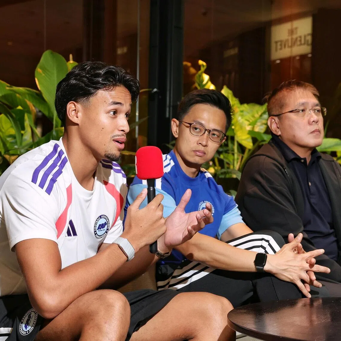 (From left) Singapore national football team forward Ilhan Fandi, head coach Gavin Lee and FAS deputy president Desmond Ong taking part in an interview with MoneyFM Sports Minutes’ Zia-ul Raushan and The Straits Times’ Deepanraj Ganesan at ParkRoyal Collection Marina Bay on Aug 11.