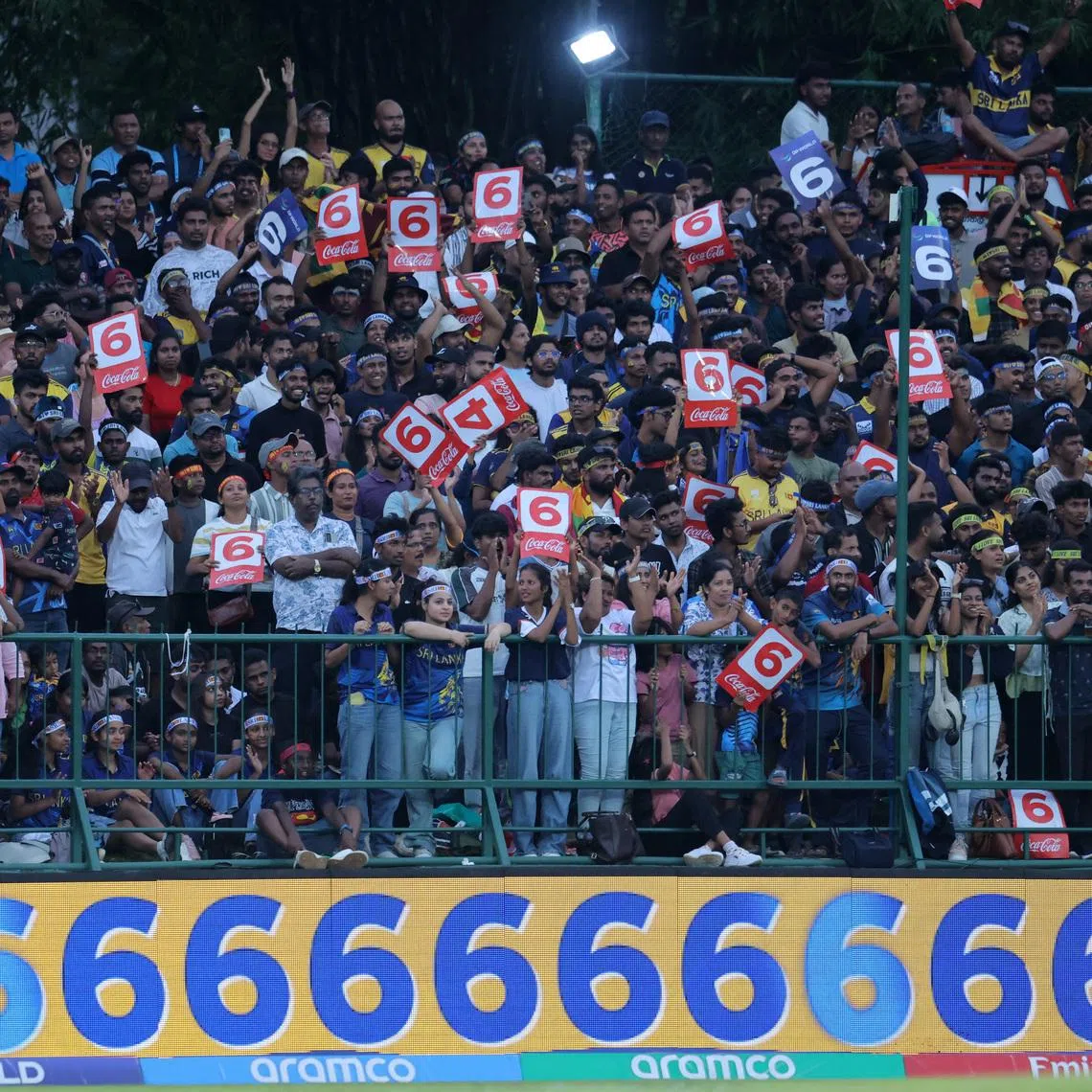 Cricket - ICC Men's T20 World Cup 2026 - Super 8 - Sri Lanka v England - Pallekele International Cricket Stadium, Kandy, Sri Lanka - February 22, 2026 Sri Lanka fans celebrate after Dasun Shanaka hits six runs off the bowling of England's Jamie Overton REUTERS/Lahiru Harshana