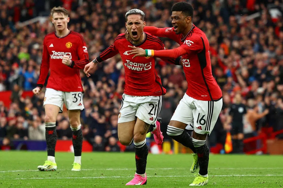 Soccer Football - FA Cup - Quarter Final - Manchester United v Liverpool - Old Trafford, Manchester, Britain - March 17, 2024 Manchester United's Antony celebrates scoring their second goal with Amad Diallo REUTERS/Molly Darlington