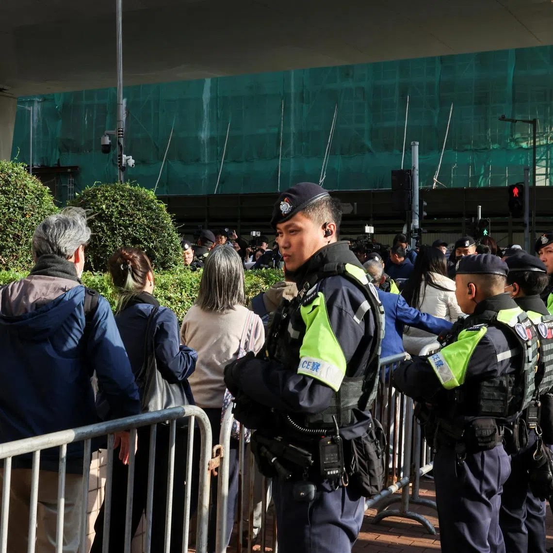 People queue to enter the West Kowloon Magistrates' Courts building for sentencing in the national security collusion trial of Jimmy Lai, founder of the now-defunct pro-democracy newspaper Apple Daily, in Hong Kong, China, February 9, 2026. REUTERS/Tyrone Siu