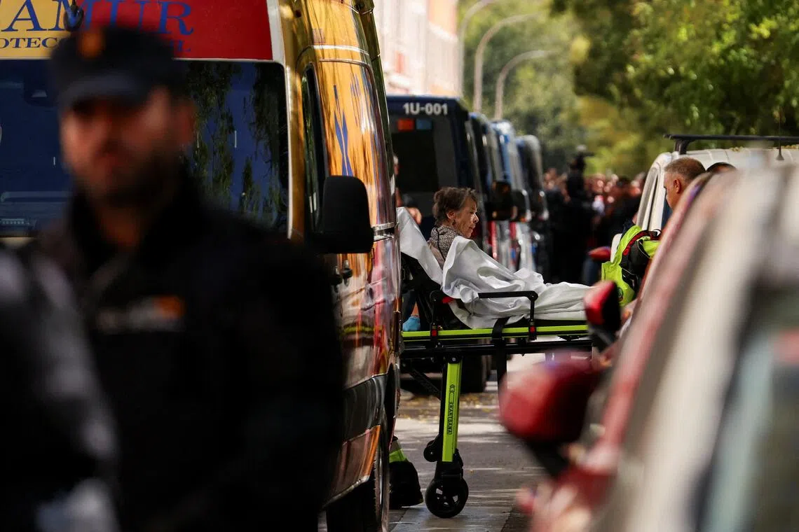 Maricarmen Abascal, 87, is transported on a stretcher to an ambulance, after she was evicted from the Madrid home where she had lived for more than 70 years.