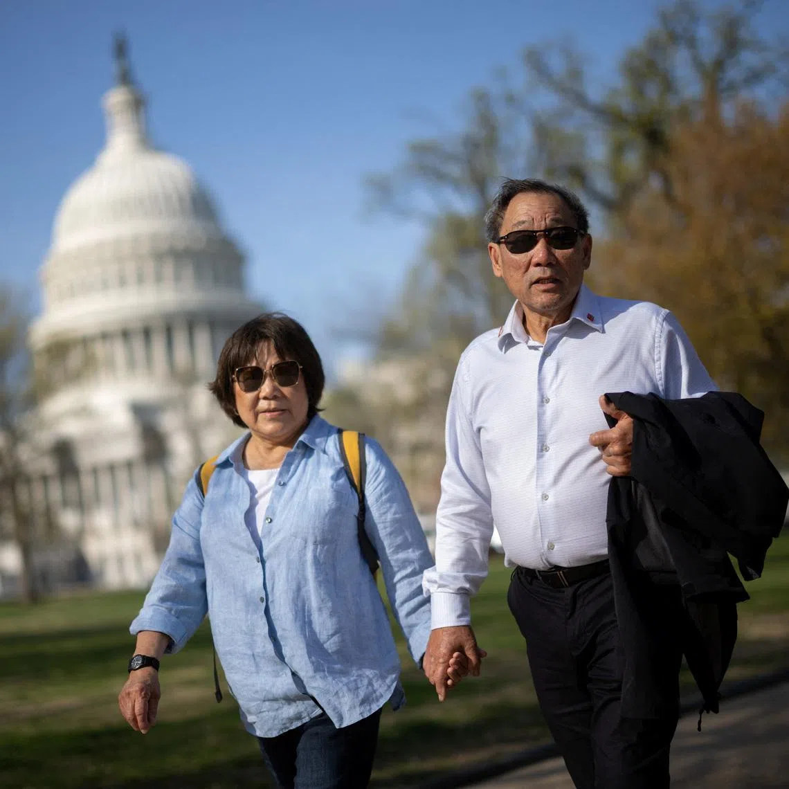 Norman Wong, the great-grandson of Wong Kim Ark, and his wife Maureen walk by the U.S. Capitol building as they arrive at demonstration outside the U.S. Supreme Court building on the day the court hears oral arguments on the legality of the Trump administration's effort to limit birthright citizenship for the children of immigrants, in Washington, D.C., U.S., April 1, 2026. In 1898, Wong Kim Ark challenged the U.S. government after being denied re-entry to the country following a trip to his parents' homeland. Though he was born in the United States, authorities claimed he was not a citizen. The Supreme Court ruled in his favor, firmly establishing that the 14th Amendment guarantees birthright citizenship. REUTERS/Carlos Barria