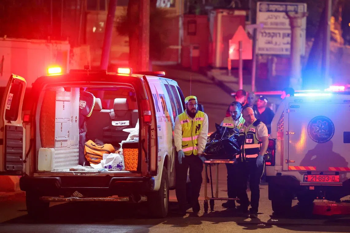 Medics in Jerusalem carry away the body of the suspected attacker, after he was killed by Israeli forces.