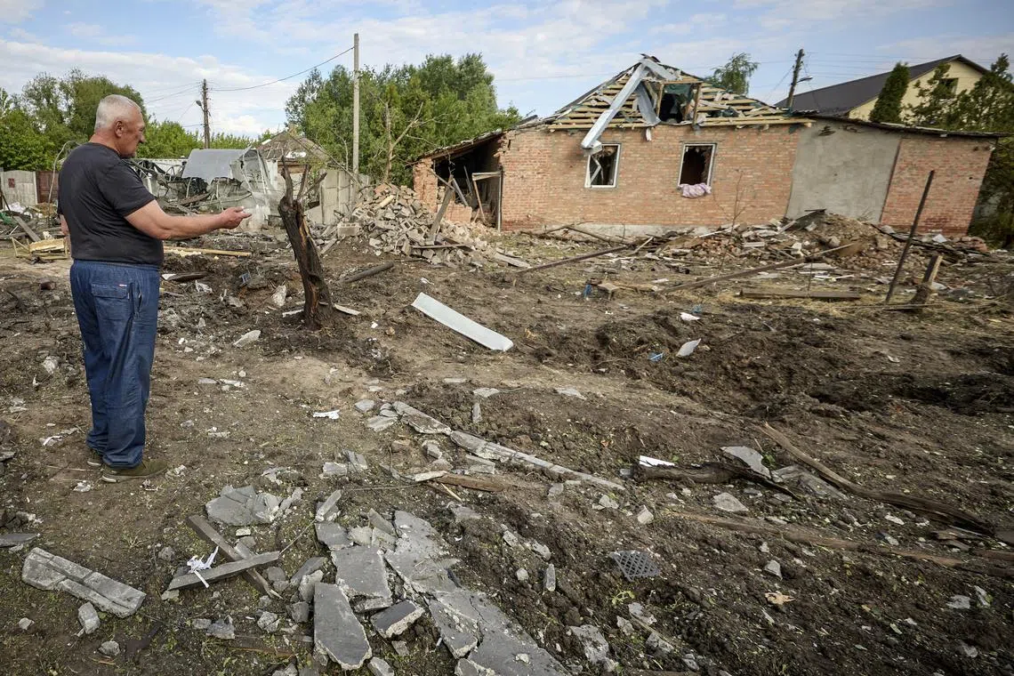 Locals and journalists gather near a site of a glide bomb shelling of a private building in Kharkiv, Ukraine.