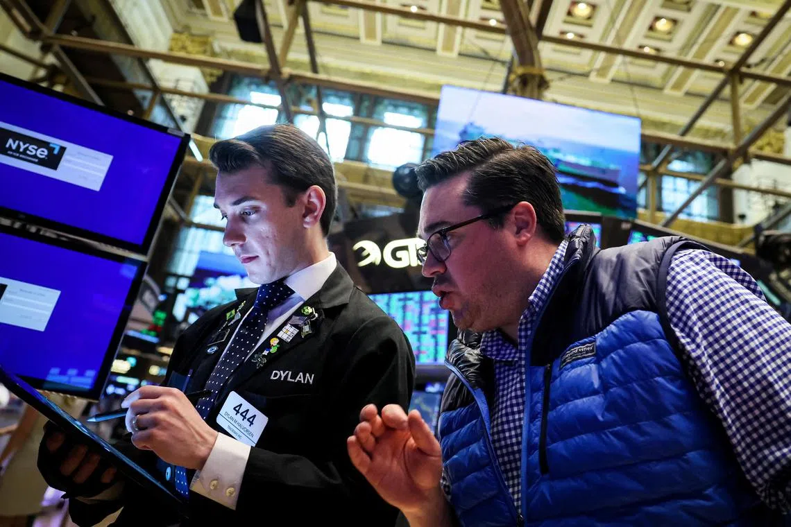 Traders work on the floor of the New York Stock Exchange, in New York City.
