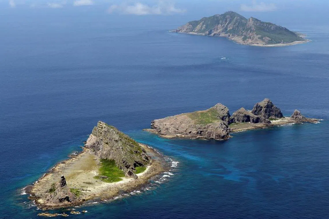 FILE PHOTO: A group of disputed islands, Uotsuri island (top), Minamikojima (bottom) and Kitakojima, known as Senkaku in Japan and Diaoyu in China is seen in the East China Sea, in this photo taken by Kyodo September 2012. Mandatory credit. REUTERS/Kyodo/File Photo