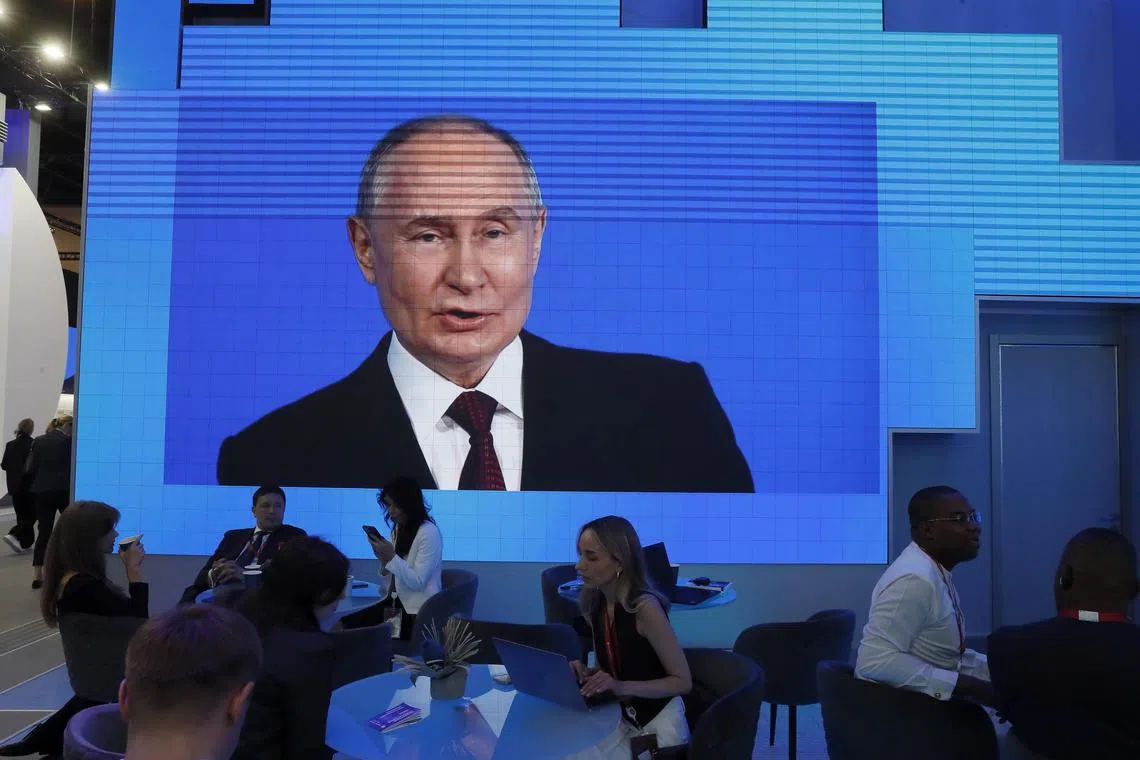A large screen shows Russian President Vladimir Putin at the St Petersburg International Economic Forum on June 7.