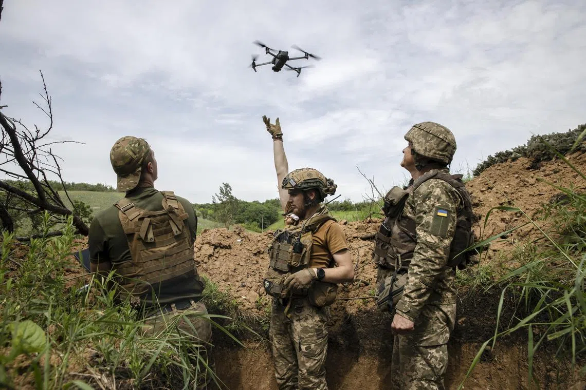 Soldiers with Ukraine's 28th Mechanised Brigade operate a drone from their position, several kilometres south of Bakhmut, Ukraine.
