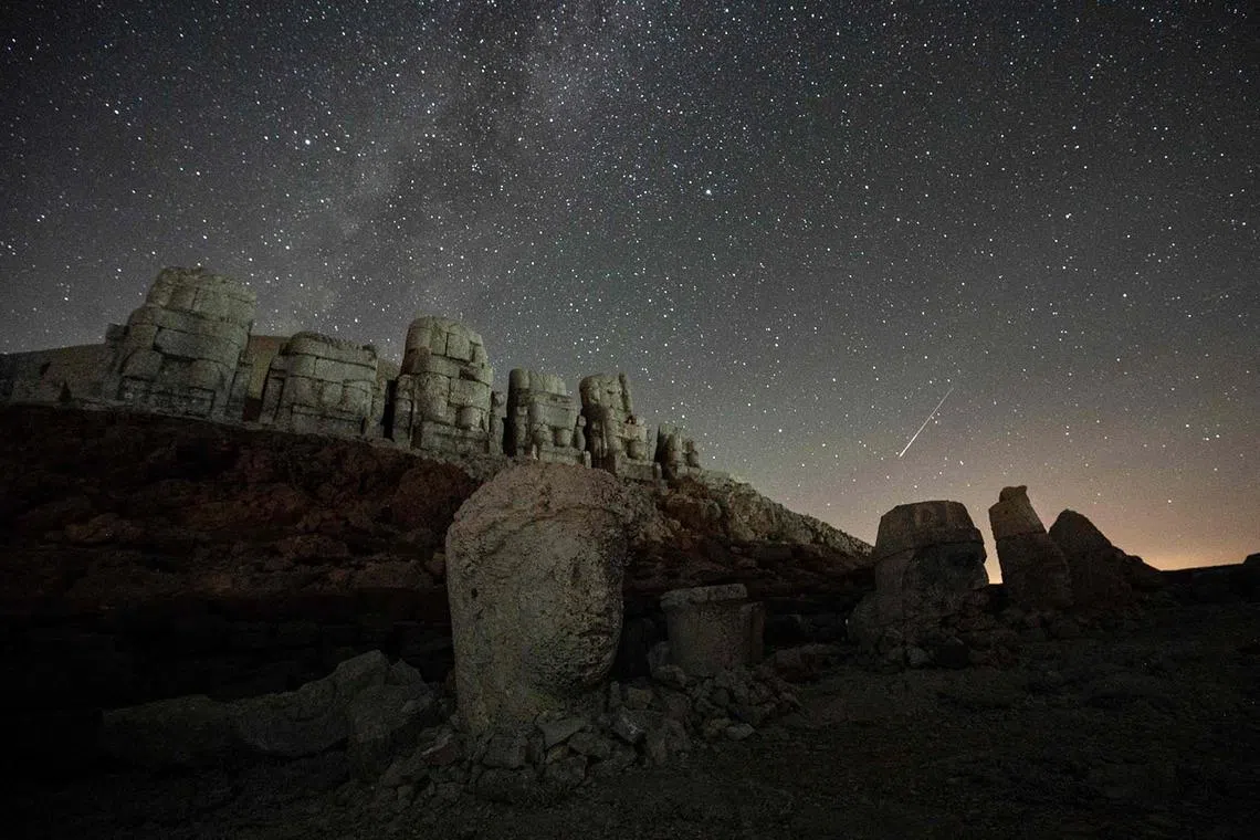 The massive stone head sculptures at the archaeological site of Mount Nemrut in southeastern Turkey, on Aug 11, 2024, the night of the Perseid meteor shower. 