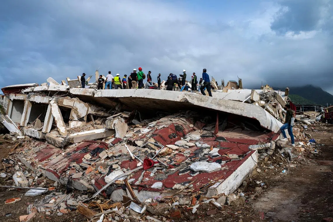 Volunteers and rescuers help to find survivors in a collapsed building in Caraballeda, La Guaira state, Venezuela, on June 30, 2026, following the June 24 twin earthquakes.  MIGUEL MEDINA/Pool via REUTERS