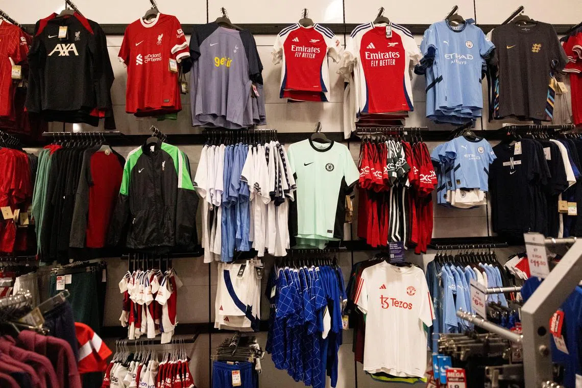 FILE PHOTO: A local store displays different Premier League football jerseys including Arsenal, Liverpool, Manchester City and others, in Brighton, Britain, May 31, 2024. REUTERS/Carlos Jasso