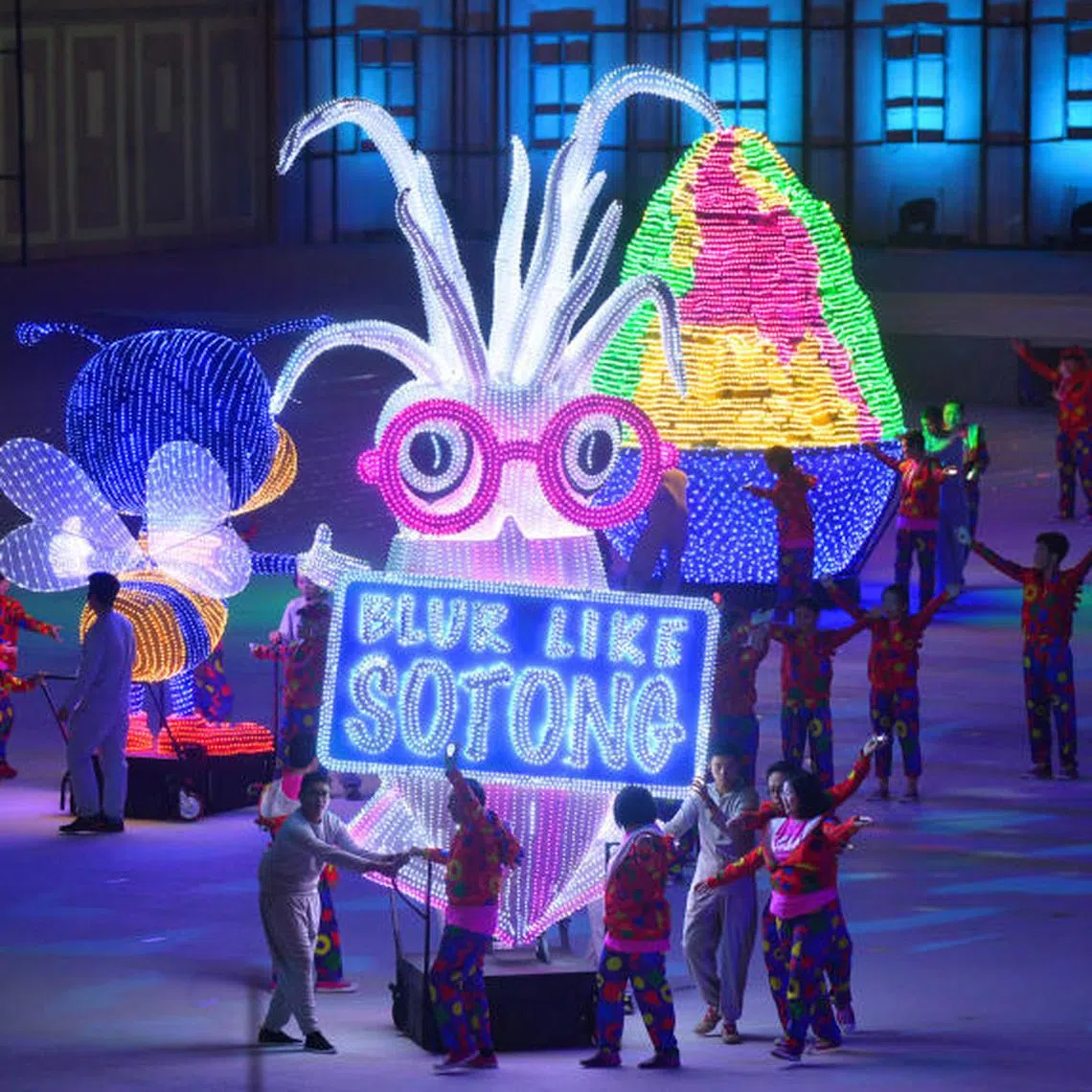 Performers from the People’s Association with large props showcasing Singapore’s unique identity at the preview of the National Day Parade at Padang on Aug 1, 2015.