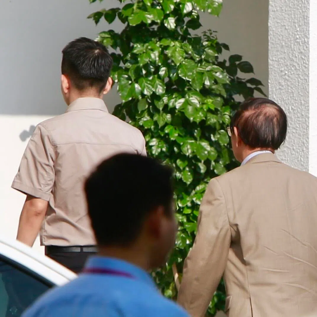 Detained Cambodian opposition leader Kem Sokha (right) attends a hearing at the Municipal Court in Phnom Penh, Cambodia, on April 8.