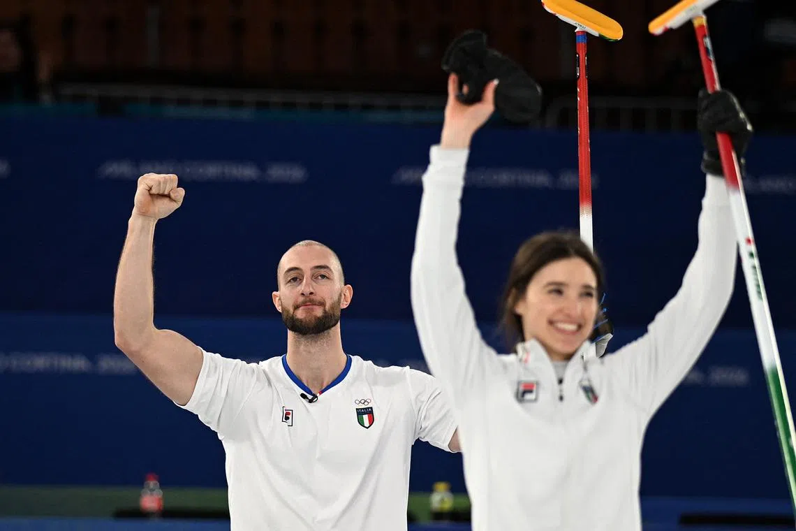 Milano Cortina 2026 Olympics - Curling - Mixed Doubles Bronze Medal Game - Great Britain vs Italy - Cortina Curling Olympic Stadium, Cortina d'Ampezzo, Italy - February 10, 2026. Amos Mosaner of Italy celebrates winning with Stefania Constantini of Italy their bronze medal match against Bruce Mouat of Britain and Jennifer Dodds of Britain REUTERS/Jennifer Lorenzini