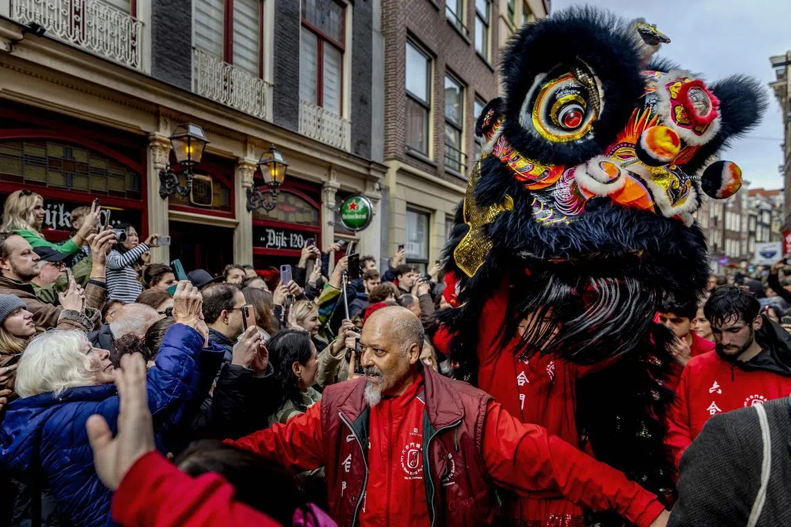 A lion dance team performing on a street in Amsterdam on Feb 10, 2024, on the first day of the Lunar New Year of the Dragon.