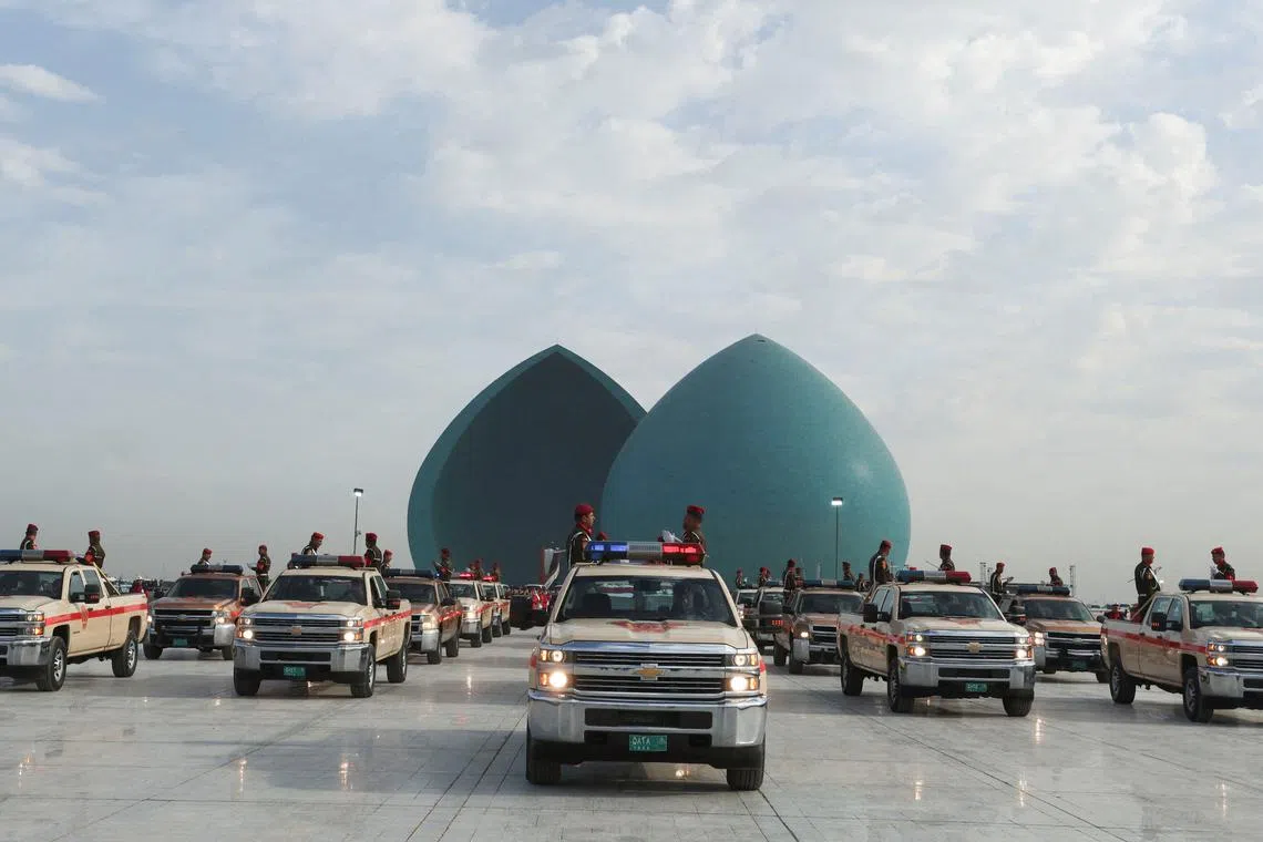 FILE PHOTO: Military vehicles belonging to the Iraqi security forces carry body remains of people from the minority Yazidi, who were killed by Islamic State militants, after they were exhumed from a mass grave in Sinjar, during a funeral ceremony in Baghdad, Iraq January 22, 2024. REUTERS/Ahmed Saad/File Photo