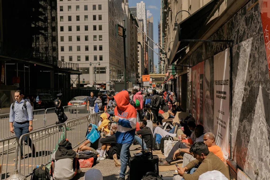 FILE — Migrants wait outside of the Roosevelt Hotel to be processed in New York, on Aug 1, 2023. The influx of asylum seekers has the makings of a potent political force, and Republicans are ready to test it in key 2024 house races. (Jeenah Moon/The New York Times)
