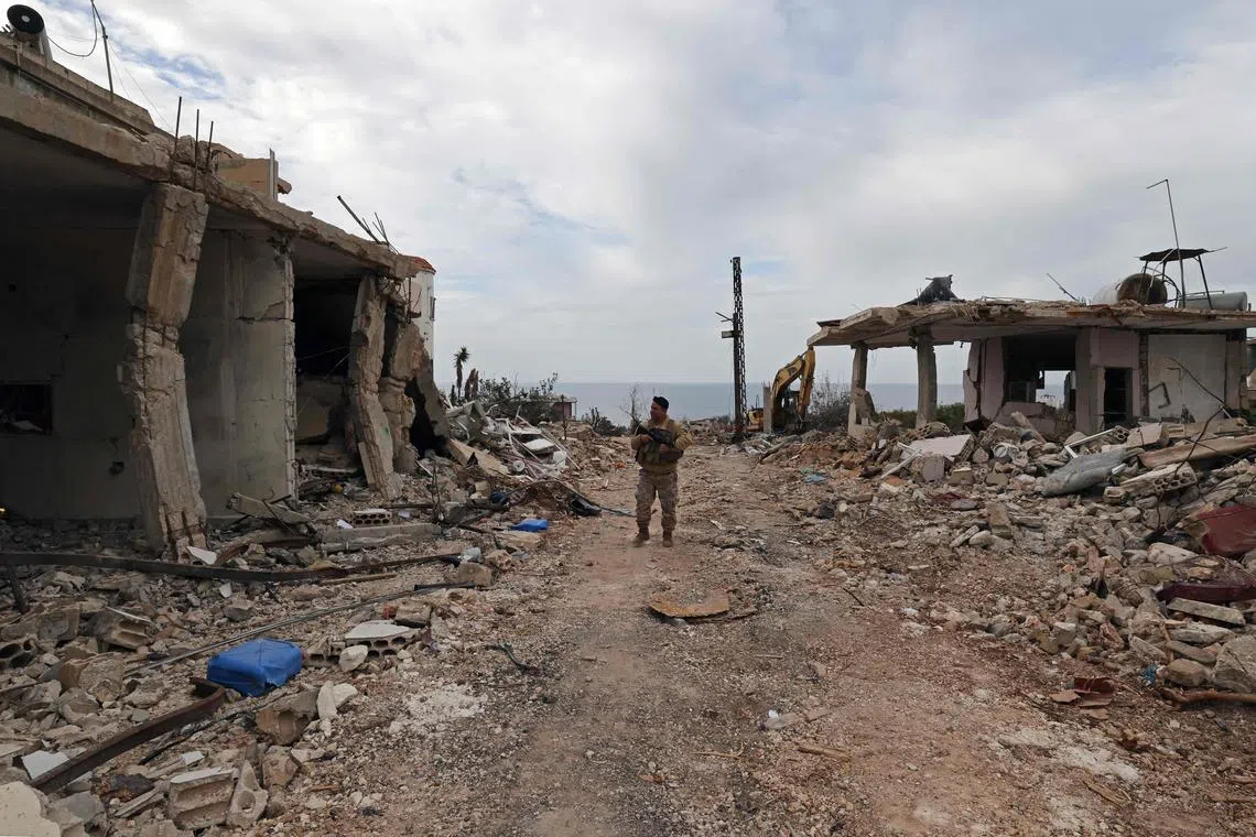 A Lebanese soldier patrols along a residential area that was devastated by the war between Israel and Hezbollah.