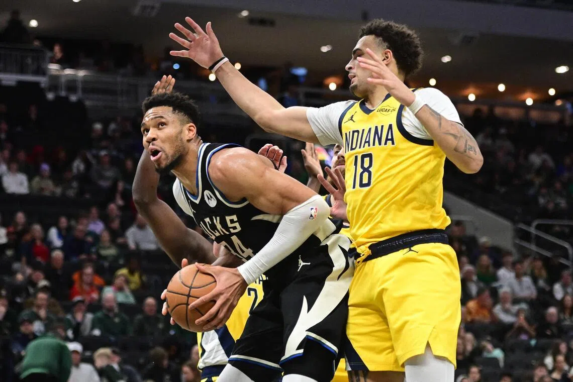 Milwaukee Bucks forward Giannis Antetokounmpo looks for a shot against Indiana Pacers forward Jalen Slawson in the second quarter at Fiserv Forum.