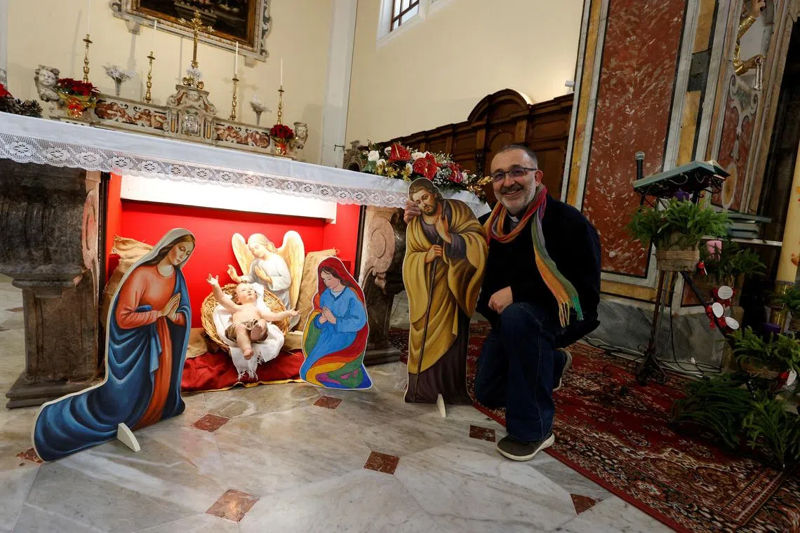 FILE PHOTO: Parish priest of the Church of Saints Peter and Paul, Vitaliano Della Sala poses for a photo in front of a nativity scene featuring two mothers of the Baby Jesus, instead of the conventional Mary and Joseph figurines in Capocastello di Mercogliano, Italy December 23, 2023. REUTERS/Ciro De Luca/File Photo