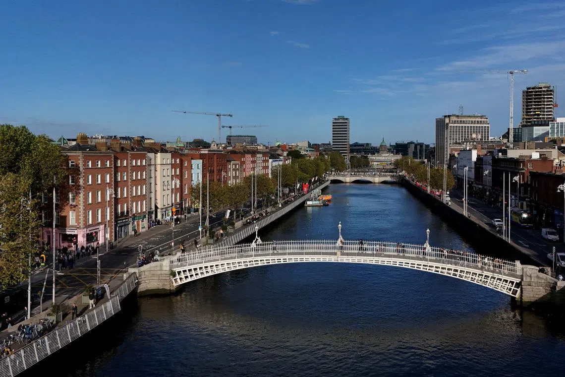 FILE PHOTO: A drone view shows people walking over the Ha'penny Bridge on the river Liffey with the Spire visible, in the city centre of Dublin, Ireland October 7, 2024. REUTERS/Clodagh Kilcoyne/File Photo