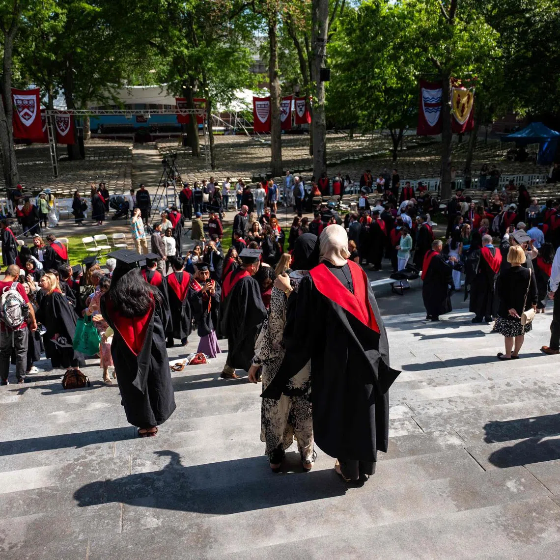 Students, faculty and family pose for pictures at Harvard Yard on May 28.